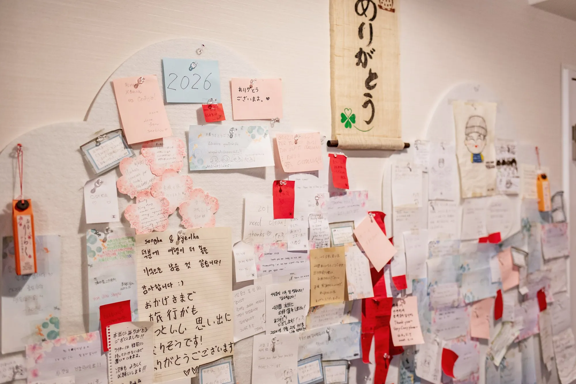 Wall of handwritten notes left by guests